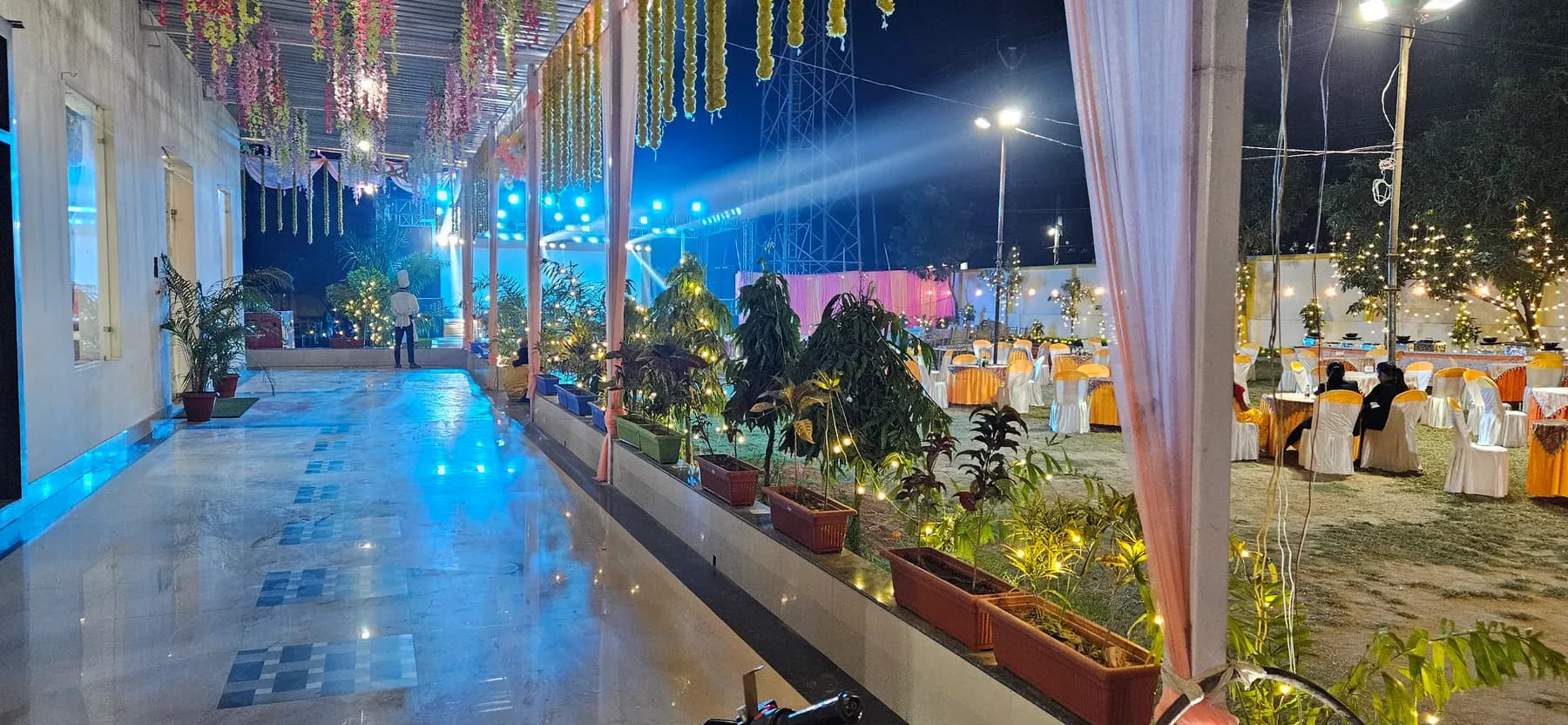 Decorated walkway corridor with hanging florals and lights
