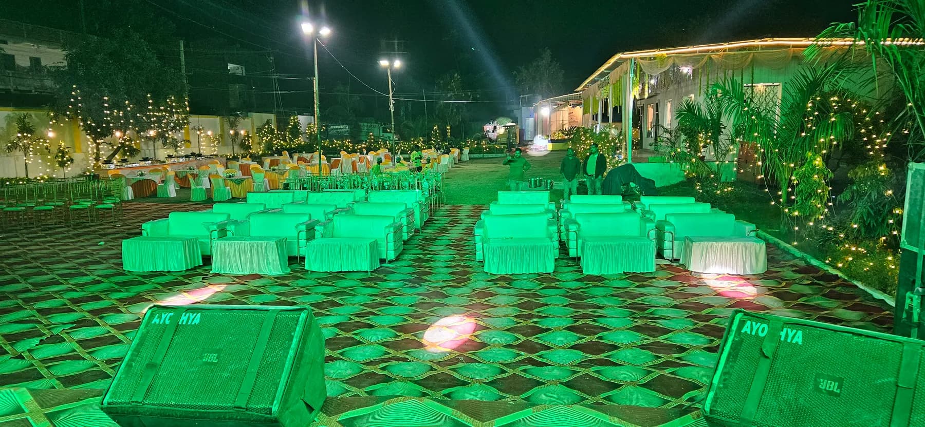 Outdoor lawn sofa seating with green lighting